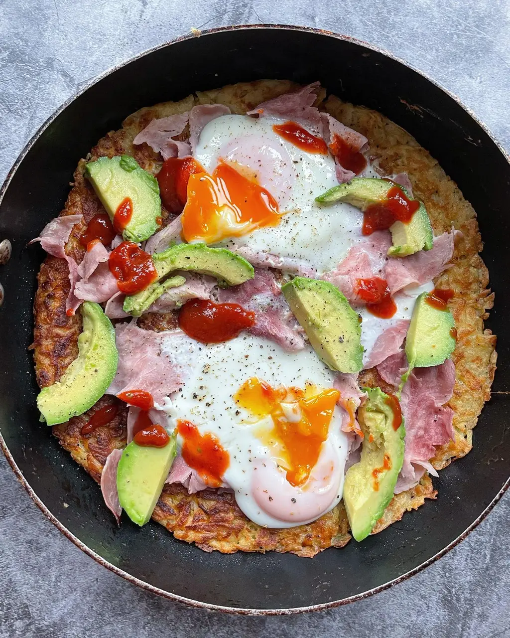 Crispy Potato Rosti with Eggs, Smoked Turkey, Avocado & Sriracha