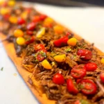 Slow-Braised Shredded Beef Flatbread with Caramelized Onions & Cherry Tomatoes