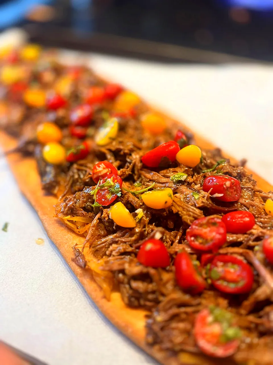 Slow-Braised Shredded Beef Flatbread with Caramelized Onions & Cherry Tomatoes